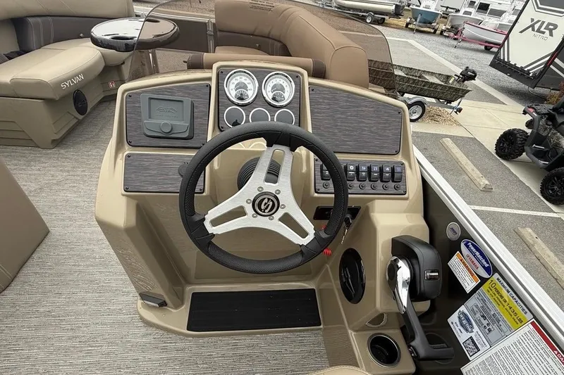 Slide: The Image of 2026 Sylvan Mirage 822 PARTY FISH boat dashboard with steering wheel and controls. - 17