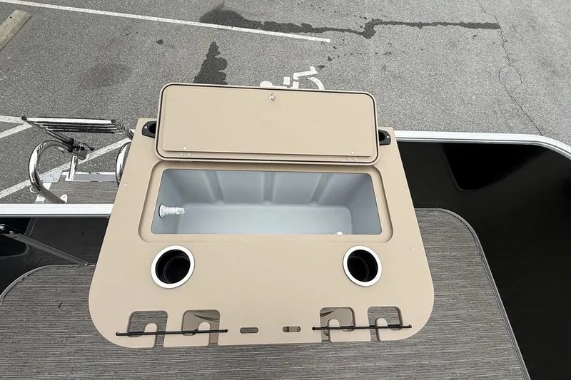 Slide: The Image of 2026 Sylvan Mirage 822 PARTY FISH boat with open storage compartment and cup holders. - 18