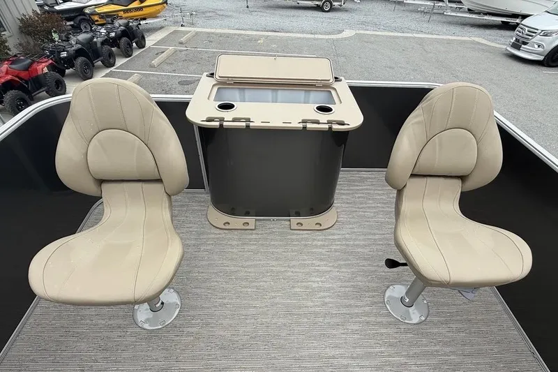 Slide: The Image of 2026 Sylvan Mirage 822 PARTY FISH boat interior with beige seats and storage unit. - 19