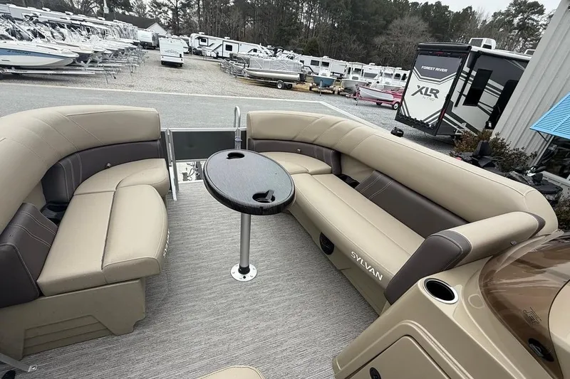 Slide: The Image of 2026 Sylvan Mirage 822 PARTY FISH pontoon boat interior with seating and table. - 21