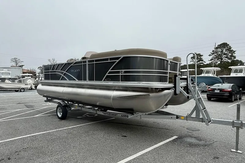 Slide: The Image of 2026 Sylvan Mirage 822 PARTY FISH pontoon boat on trailer in parking lot. - 4