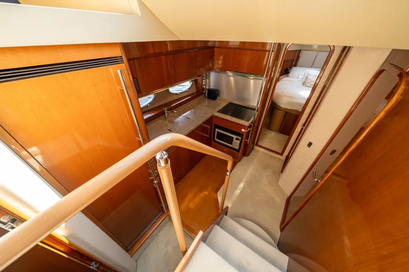 Slide: The Image of Luxurious interior of 2008 Princess 58 Flybridge yacht, featuring kitchen and bedroom. - 25