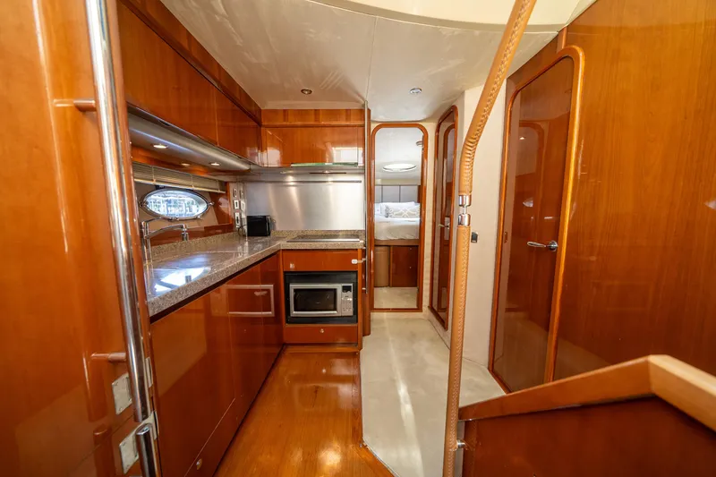 Slide: The Image of Luxurious kitchen interior of 2008 Princess 58 Flybridge yacht with wood finish. - 26