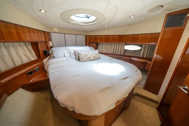 Slide: The Image of Luxurious bedroom interior of 2008 Princess 58 Flybridge yacht with circular bed and wood accents. - 30