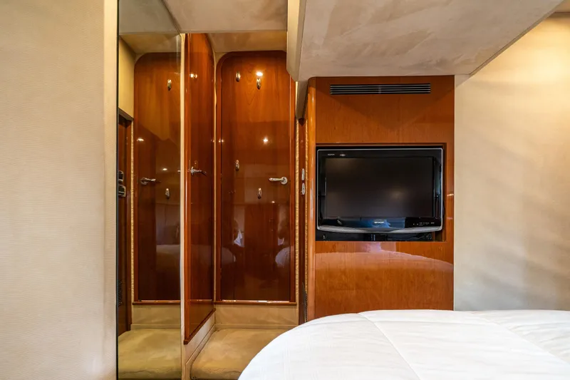 Slide: The Image of Luxurious interior of 2008 Princess 58 Flybridge yacht with wood paneling and built-in TV. - 38