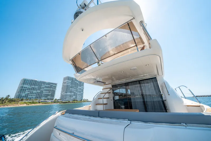 Slide: The Image of 2008 Princess 58 Flybridge yacht on water with modern buildings in background. - 42