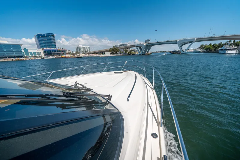 Slide: The Image of 2008 Princess 58 Flybridge yacht cruising under a bridge on a sunny day. - 44