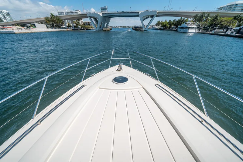 Slide: The Image of Bow view of 2008 Princess 58 Flybridge yacht navigating a scenic waterway. - 45