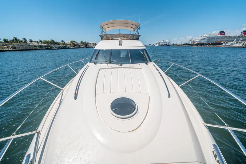 Slide: The Image of 2008 Princess 58 Flybridge yacht on calm water, clear sky, and distant ships. - 46