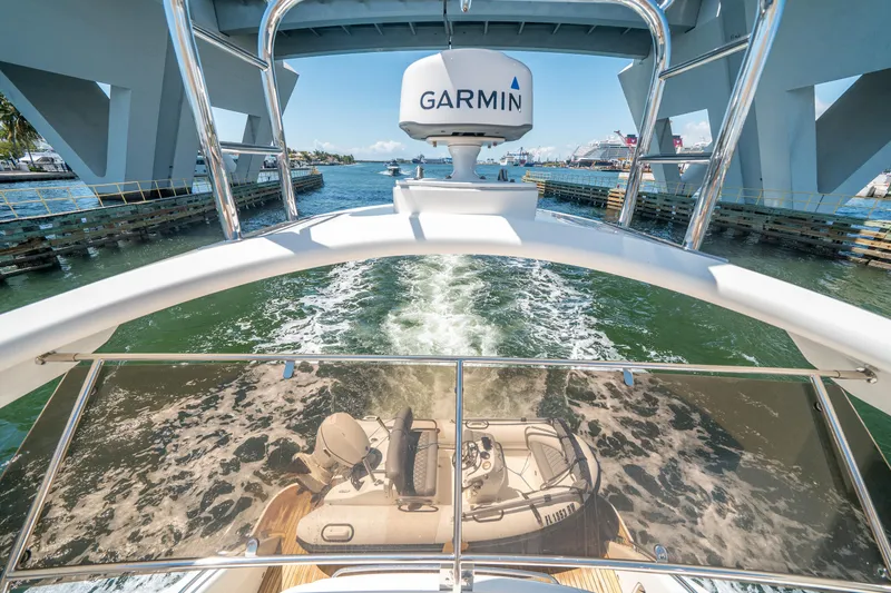 Slide: The Image of 2008 Princess 58 Flybridge yacht navigating under a bridge, featuring Garmin equipment. - 47