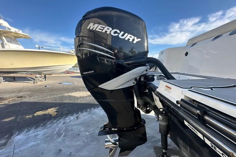 Slide: The Image of 2018 Blackfin 212 CC with Mercury Verado outboard engine, docked under clear blue sky. - 10