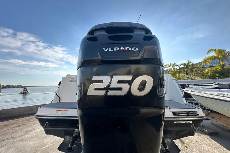Slide: The Image of 2018 Blackfin 212 CC boat with Verado 250 engine, docked by the water. - 12