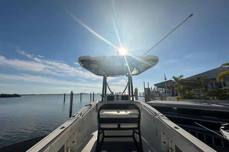 Slide: The Image of 2018 Blackfin 212 CC boat docked under sunny blue sky. - 14