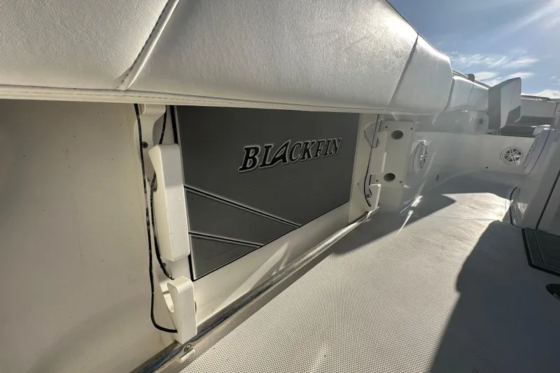 Slide: The Image of 2018 Blackfin 212 CC boat interior with logo, featuring white seating and deck. - 20