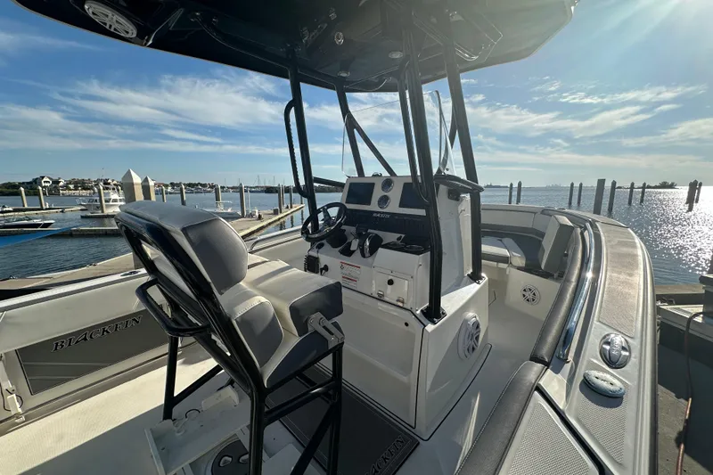 Slide: The Image of 2018 Blackfin 212 CC boat interior at marina with sunny waterfront view. - 26