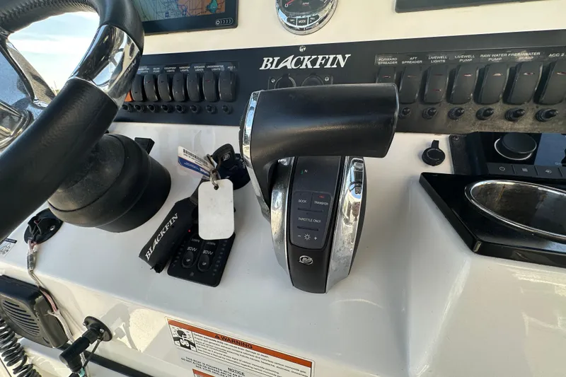 Slide: The Image of Control panel of a 2018 Blackfin 212 CC boat with steering wheel and throttle. - 34