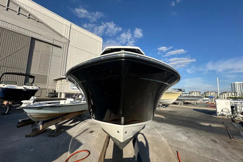 Slide: The Image of 2018 Blackfin 212 CC boat on dry dock under clear blue sky. - 4