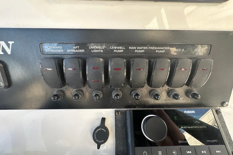 Slide: The Image of Control panel of a 2018 Blackfin 212 CC boat with labeled switches and audio system. - 40