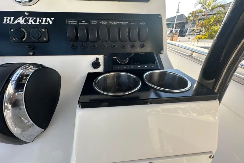 Slide: The Image of Control panel of 2018 Blackfin 212 CC boat with switches and cup holders. - 42