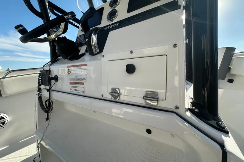 Slide: The Image of 2018 Blackfin 212 CC boat console with steering wheel and control panel. - 43