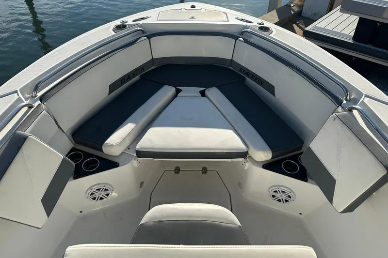 Slide: The Image of 2018 Blackfin 212 CC boat interior with cushioned seating and cup holders. - 48