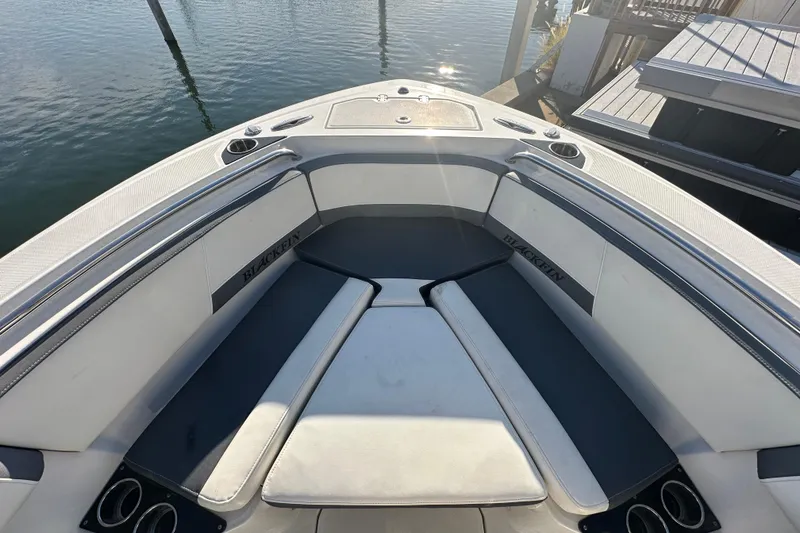 Slide: The Image of 2018 Blackfin 212 CC boat interior with cushioned seating and cup holders. - 49