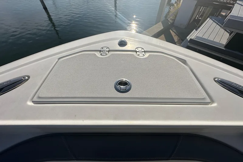 Slide: The Image of Bow of 2018 Blackfin 212 CC boat with hatch, docked by the water. - 50