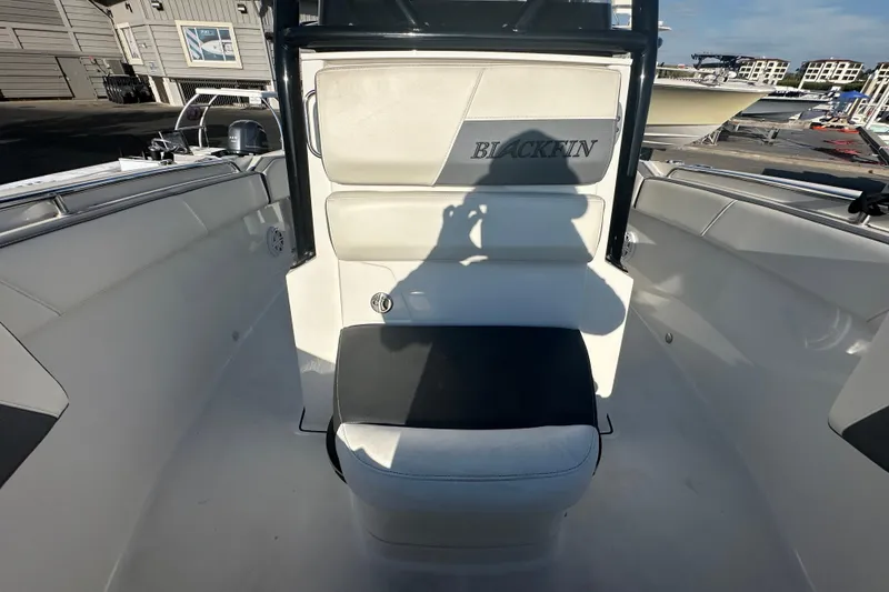 Slide: The Image of 2018 Blackfin 212 CC boat interior with seating and console, docked at marina. - 57