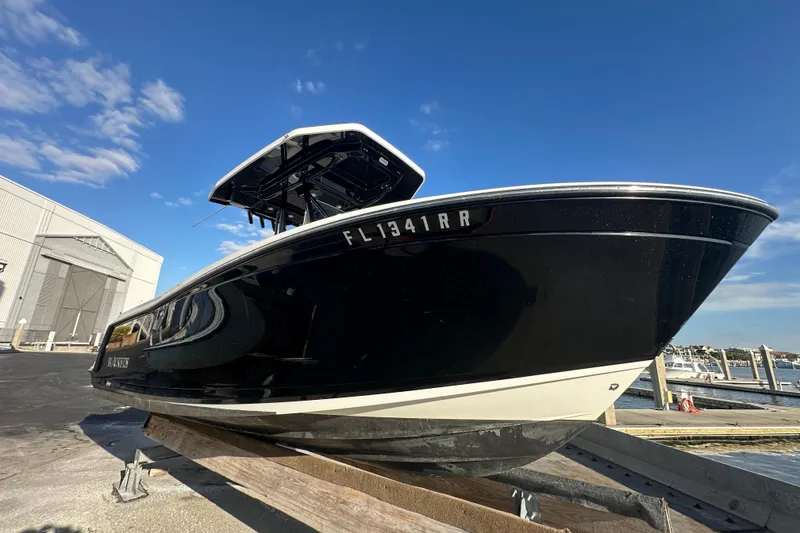 Slide: The Image of 2018 Blackfin 212 CC boat on trailer under clear blue sky. - 6