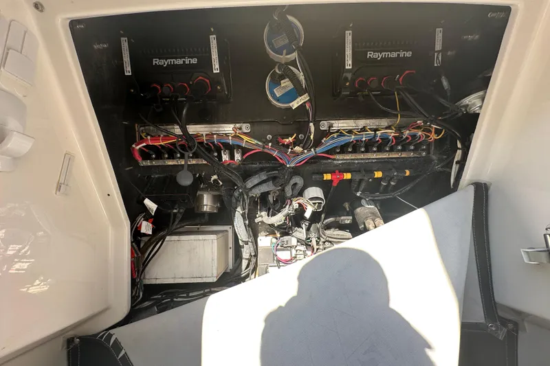 Slide: The Image of 2018 Blackfin 212 CC boat electronics compartment with Raymarine equipment and wiring. - 60