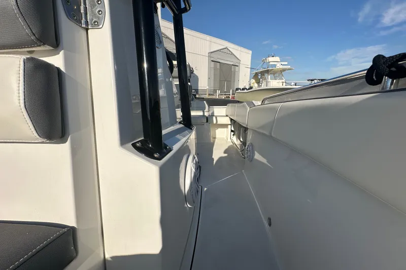 Slide: The Image of 2018 Blackfin 212 CC boat interior with seating and clear blue sky. - 62