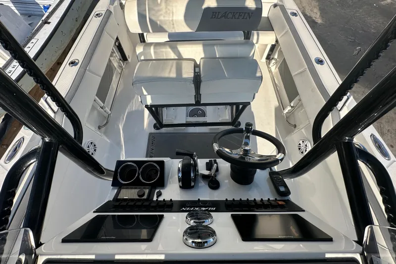 Slide: The Image of 2018 Blackfin 212 CC boat cockpit with steering wheel and controls. - 65