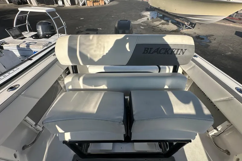 Slide: The Image of 2018 Blackfin 212 CC boat interior with cushioned seating and logo. - 68