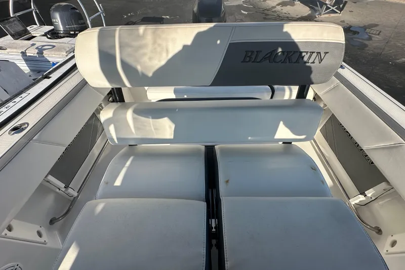 Slide: The Image of 2018 Blackfin 212 CC boat seating area with white cushions and logo. - 69