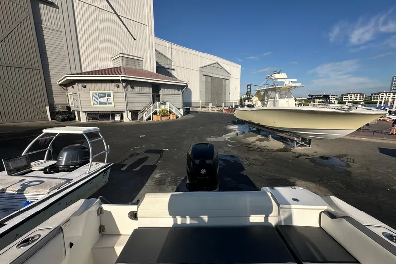Slide: The Image of 2018 Blackfin 212 CC boat at marina with other vessels and buildings in background. - 70
