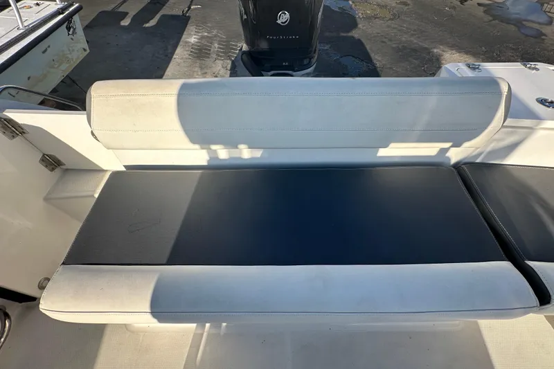 Slide: The Image of 2018 Blackfin 212 CC boat seat with cushioned backrest and black seating area. - 72