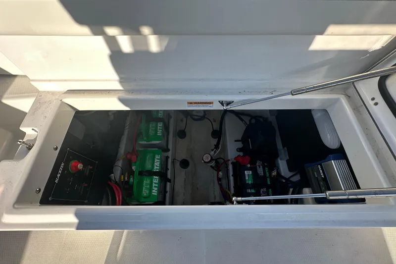 Slide: The Image of 2018 Blackfin 212 CC boat battery compartment with Interstate batteries and wiring. - 73