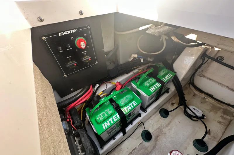 Slide: The Image of 2018 Blackfin 212 CC boat battery compartment with Interstate batteries and control panel. - 74