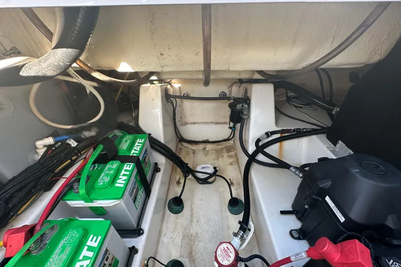 Slide: The Image of 2018 Blackfin 212 CC boat interior with batteries and wiring components. - 75