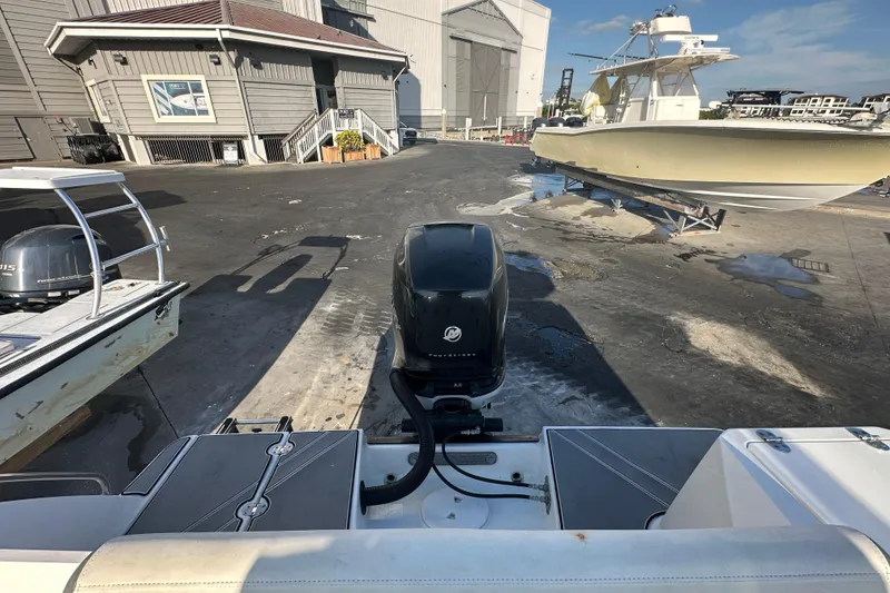 Slide: The Image of 2018 Blackfin 212 CC boat with outboard motor at a marina. - 77
