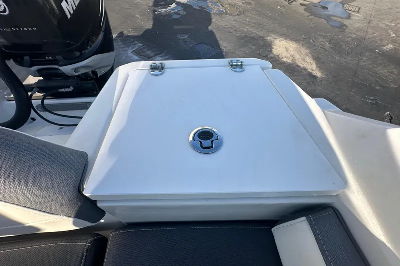 Slide: The Image of 2018 Blackfin 212 CC boat deck with storage compartment and Mercury engine. - 79