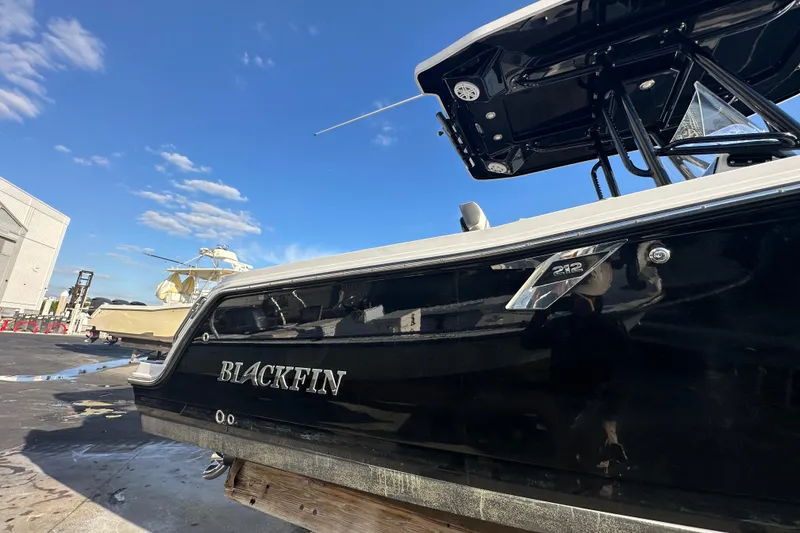 Slide: The Image of 2018 Blackfin 212 CC boat with sleek black exterior under clear blue sky. - 8