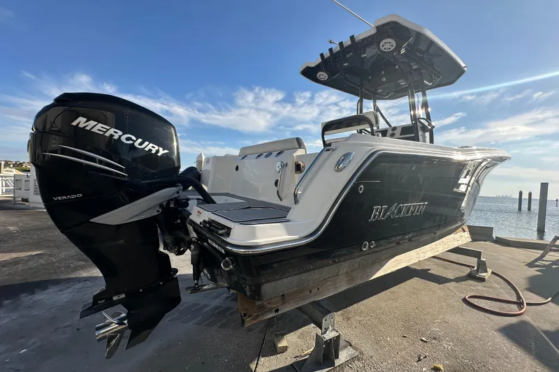 Slide: The Image of 2018 Blackfin 212 CC boat with Mercury Verado engine on a sunny dock. - 9