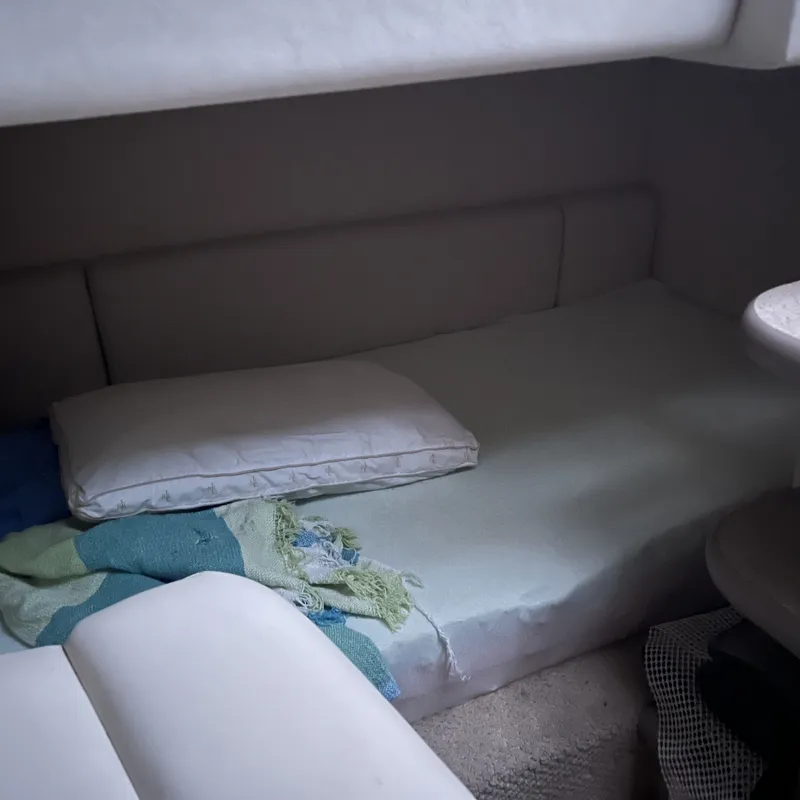 Slide: The Image of Interior cabin of 2005 Sea Ray 290 Amberjack with bed and pillow. - 10