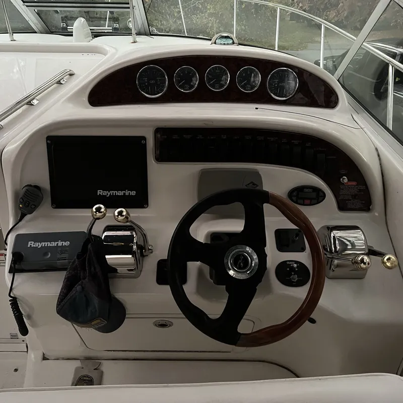 Slide: The Image of 2005 Sea Ray 290 Amberjack helm with Raymarine electronics and steering wheel. - 3