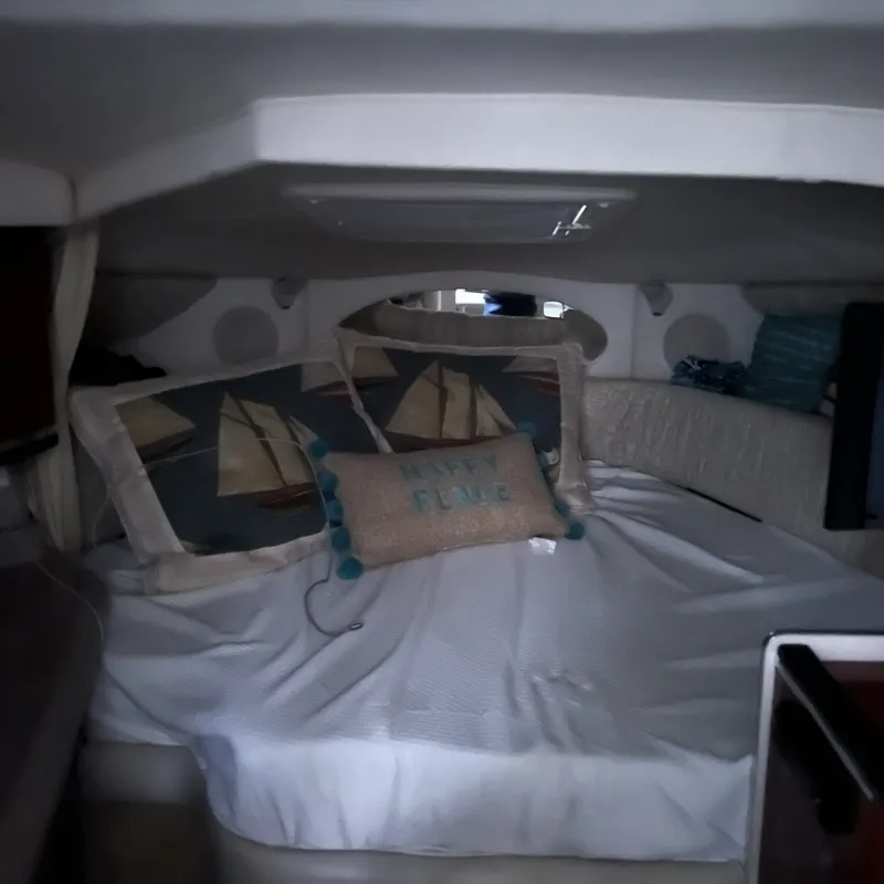 Slide: The Image of Cozy cabin interior of 2005 Sea Ray 290 Amberjack with nautical-themed pillows. - 8