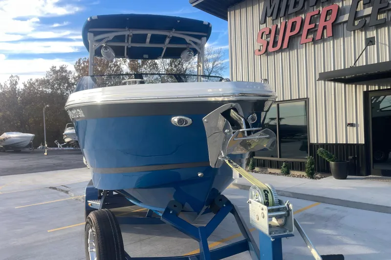 Slide: The Image of 2023 Cobalt R6 Surf boat in blue, parked outside a dealership. - 11