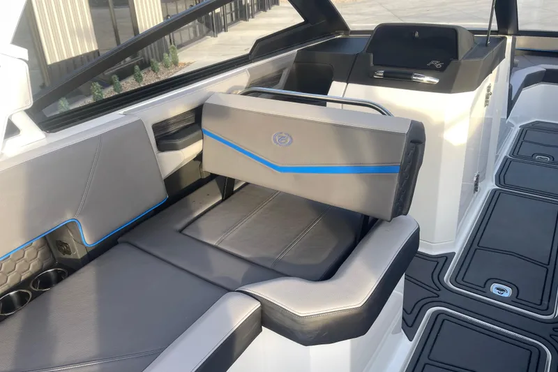 Slide: The Image of 2023 Cobalt R6 Surf boat interior with sleek gray seating and blue accents. - 19