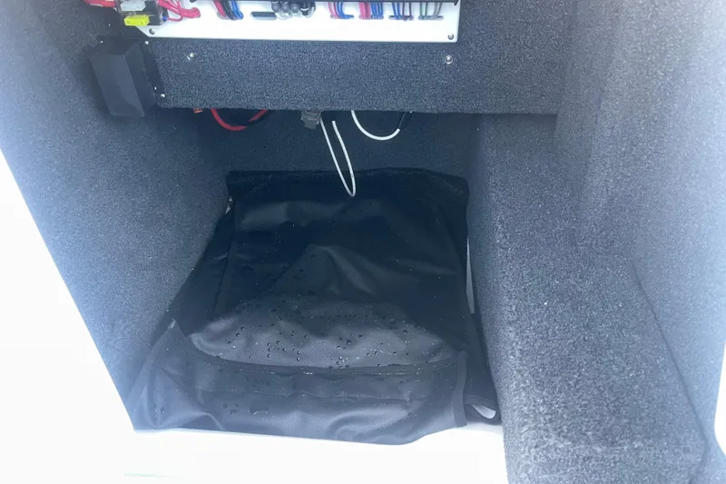 Slide: The Image of Interior compartment of 2023 Cobalt R6 Surf boat with wiring and storage. - 28