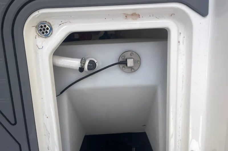 Slide: The Image of 2023 Cobalt R6 Surf boat compartment with drainage and wiring. - 30